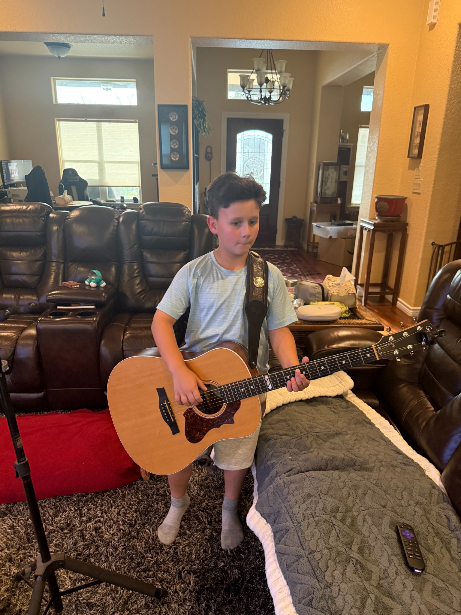 Jerrick playing guitar at home