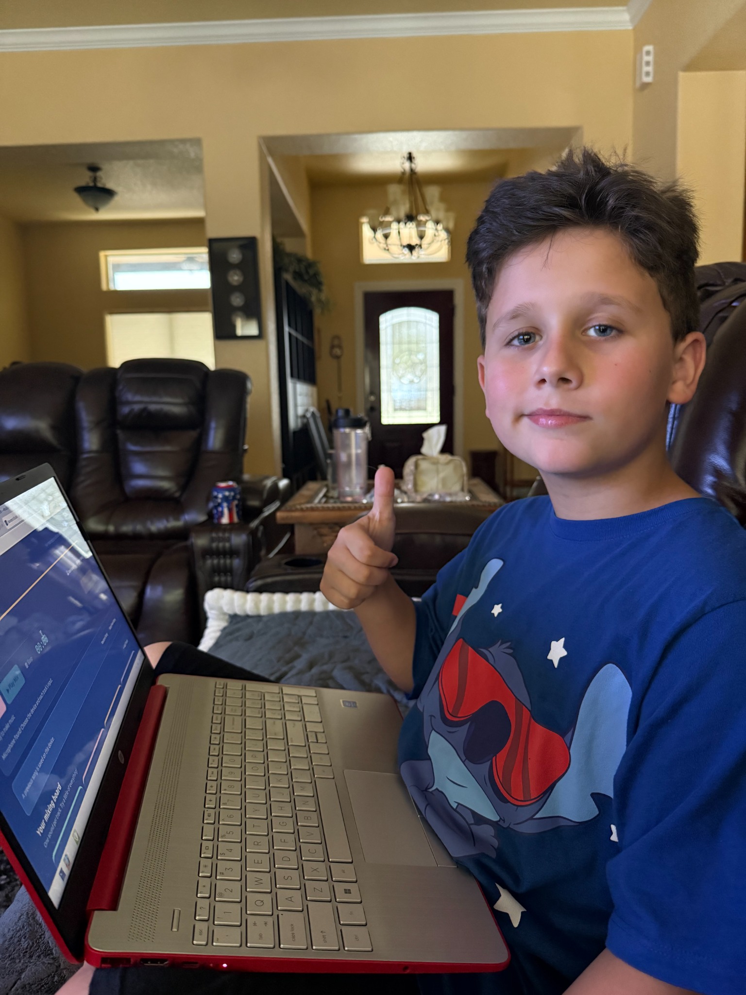 Jerrick at a laptop, giving a thumbs-up