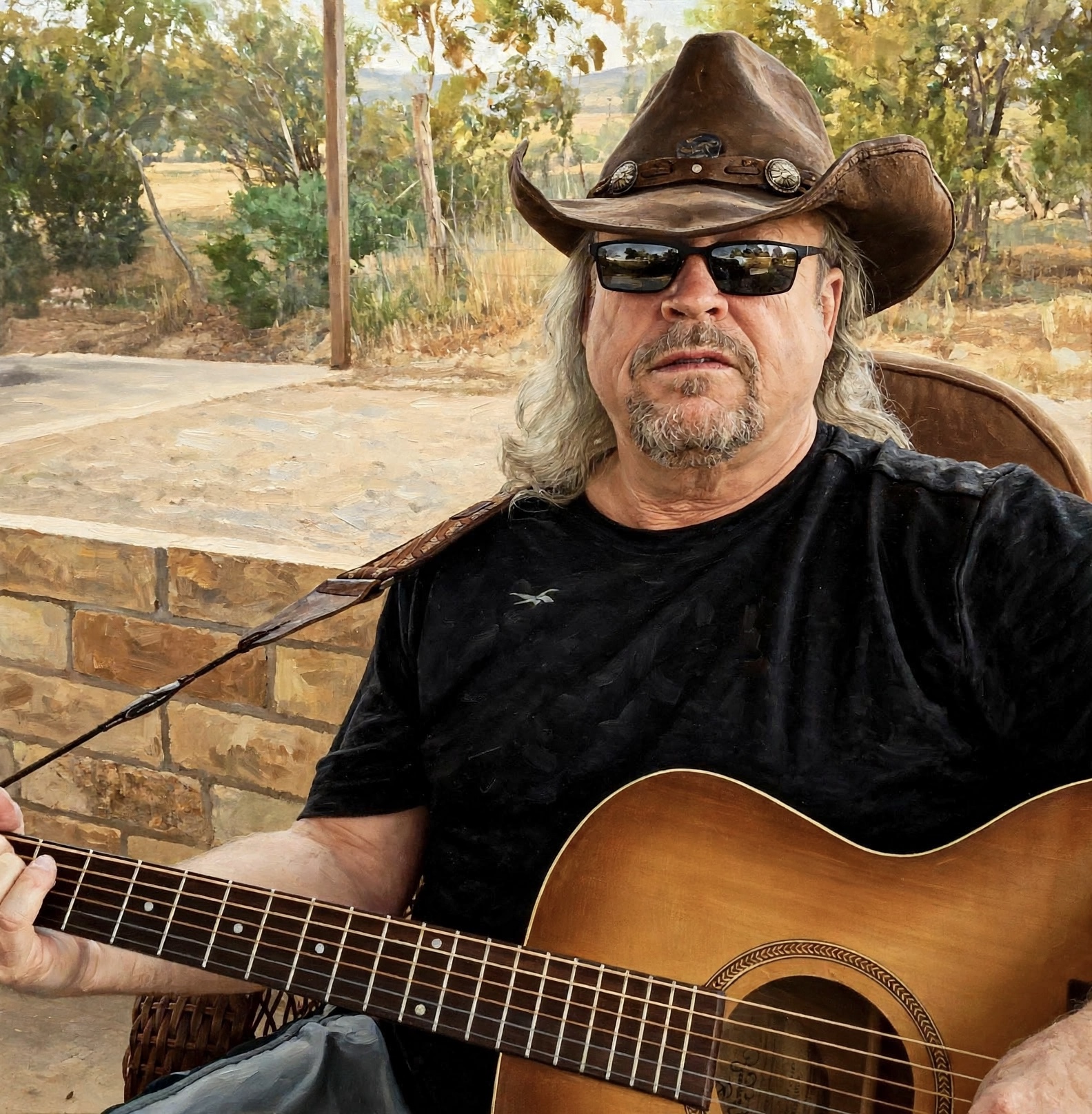 Ray with an acoustic guitar outdoors